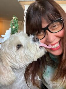 oscar the dog licks lori the owner of make it known pr in face
