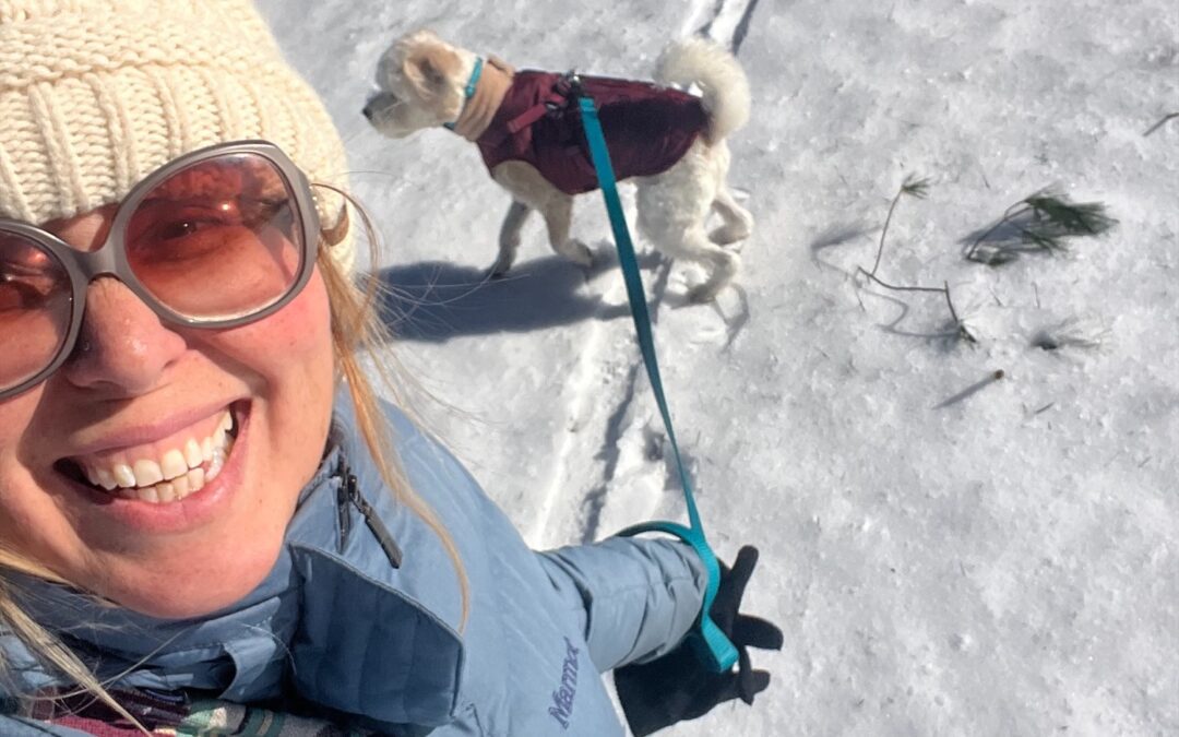 Lori taking a selfie walking her dog Oscar Wilde in the snow